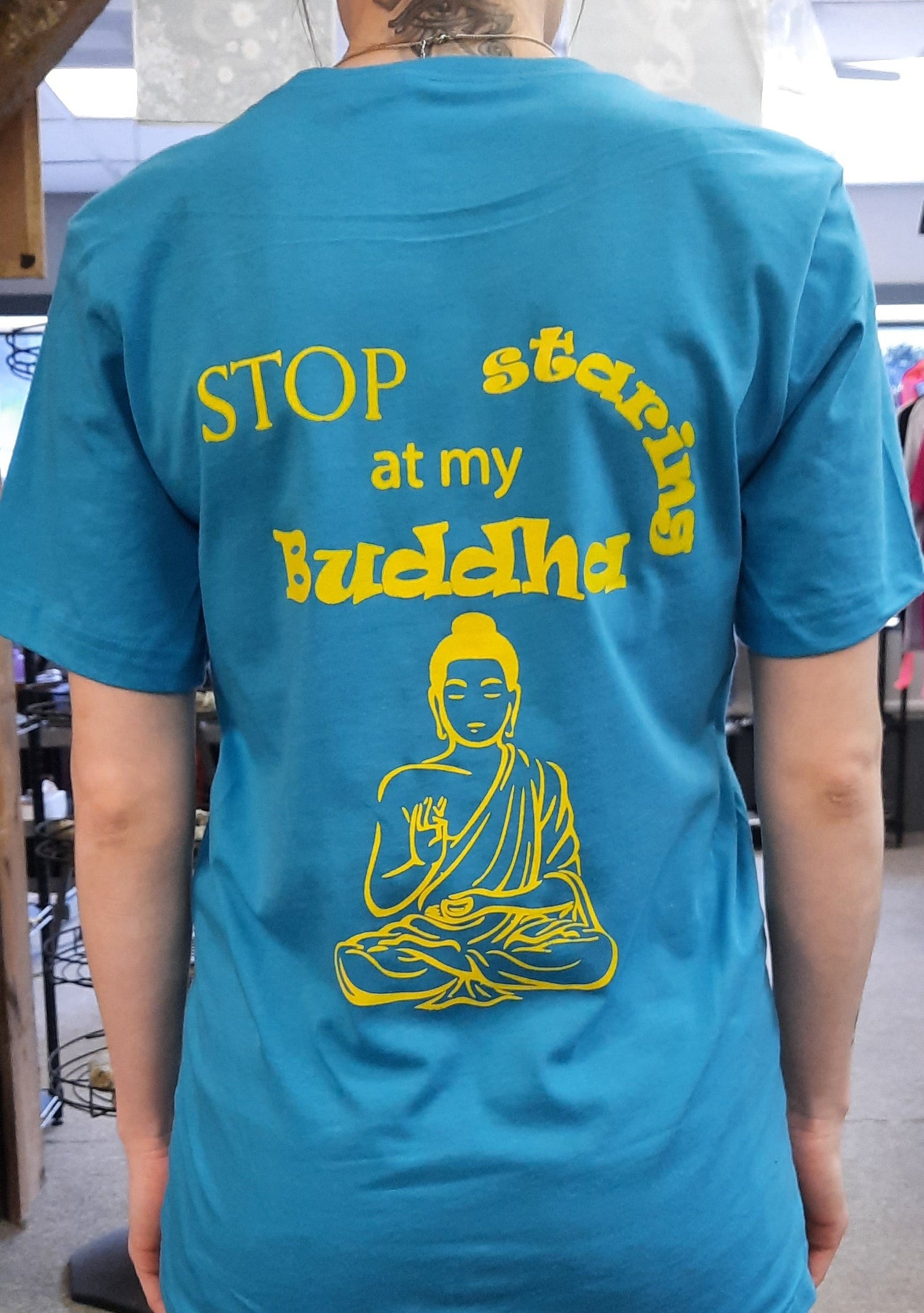 Bella Canvas short sleeve T-Shirts, size large.  "Stop staring at my Buddha" on the back, Gaia's Blessings LLC logo on front.