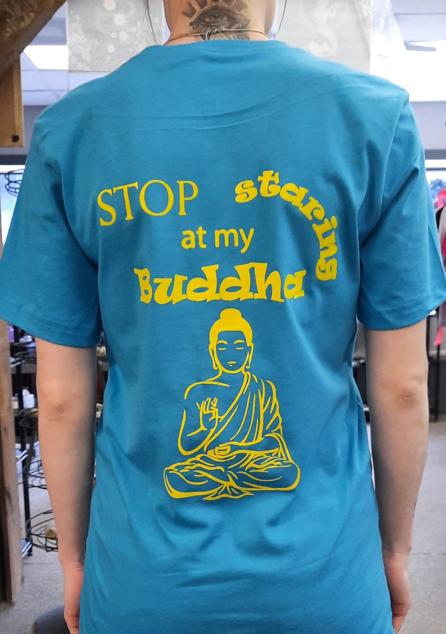 Bella Canvas short sleeve T-Shirts, size small.  "Stop staring at my Buddha" on the back, Gaia's Blessings LLC logo on front.